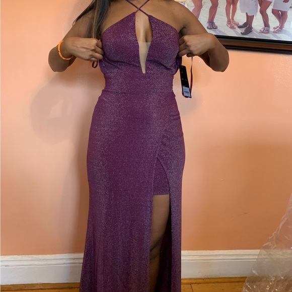 Dresses & Skirts - Fitted metallic gown with criss cross neckline and leg slit.
100% Polyester